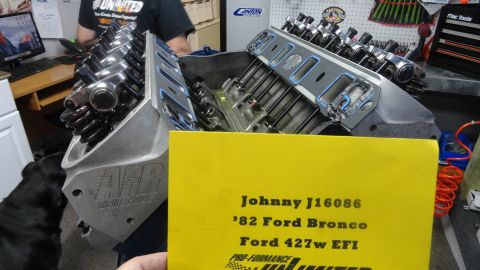 1982 Ford Bronco - A close-up view of a V8 engine block with AFR Renegade cylinder heads installed. A yellow document with text about a '82 Ford Bronco and a…