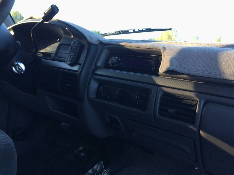 Interior view of a Ford Bronco dashboard, showing steering wheel, shifter, radio, and air vents.