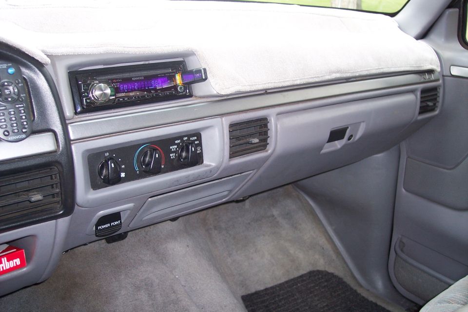 Interior of a 1995 Ford Bronco dashboard with Kenwood stereo and climate controls.