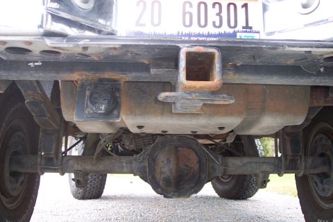 1995 Ford Bronco - Close-up view of a truck's rear axle, trailer hitch, and license plate.