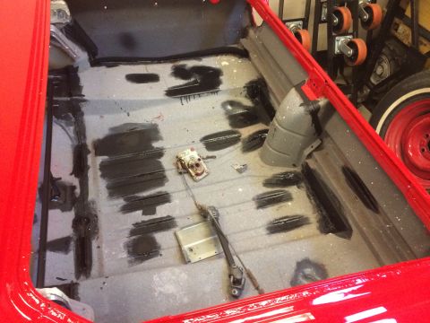 1964 Ford Fairlane - The interior floor of a car is being prepped for restoration, with visible sealant and some mechanical parts.