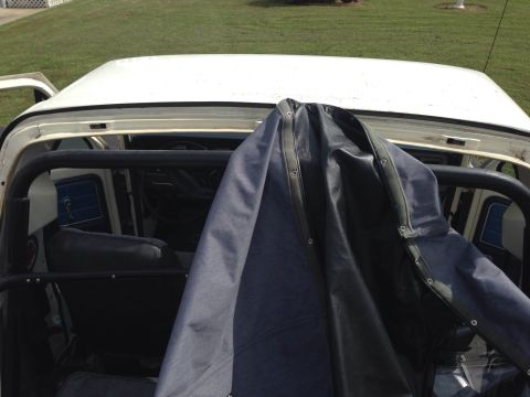 1979 Ford Bronco - The interior of a Ford Bronco is visible, partially obscured by a dark cover.