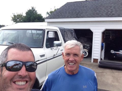 1979 Ford Bronco - A white Ford F-Series truck is parked in front of a garage with two men standing nearby.