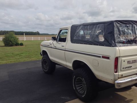 1979 Ford Bronco - 1979 Ford Bronco with a black soft top, seen from the rear three-quarter angle.