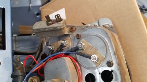 1973 Ford Bronco - The rear of a vintage instrument cluster shows electrical connections with brass terminals and black heat shrink tubing. Red, blue, and ora…