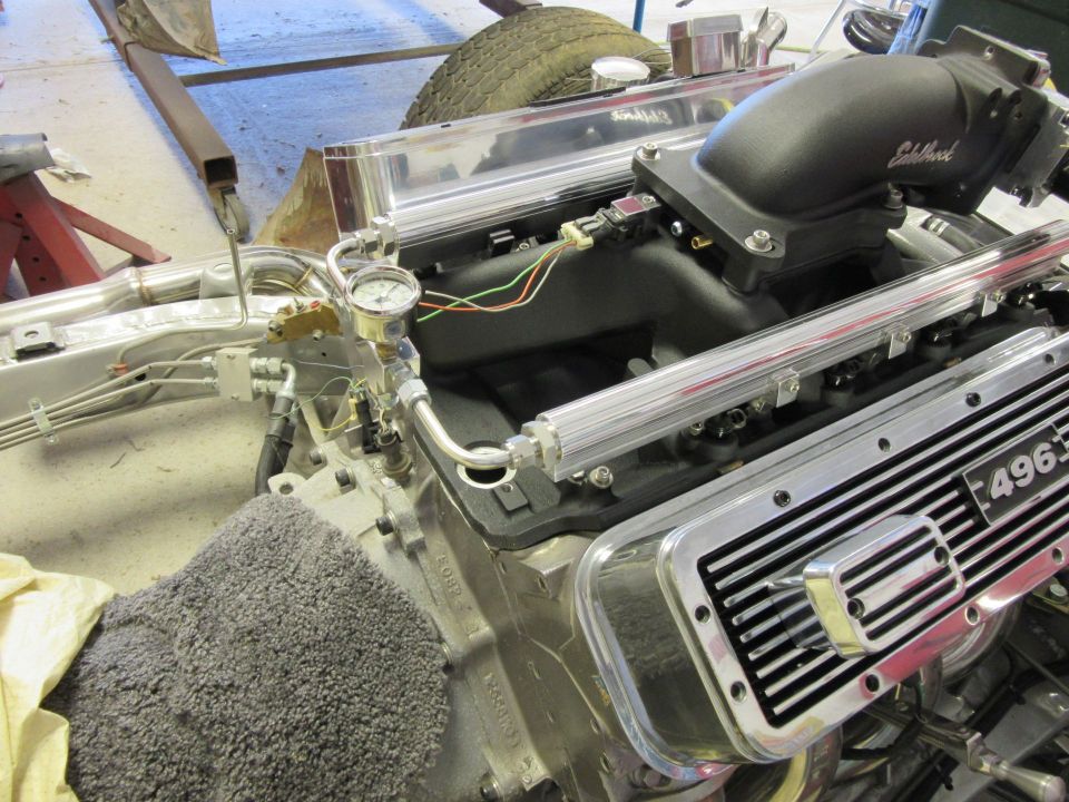 Close-up of a 496 big-block V8 engine with Edelbrock intake and chrome valve covers.