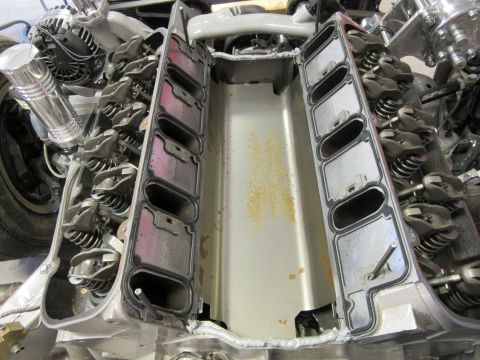 Overhead view of V8 engine intake manifold area with gaskets, rocker arms, and valve springs.
