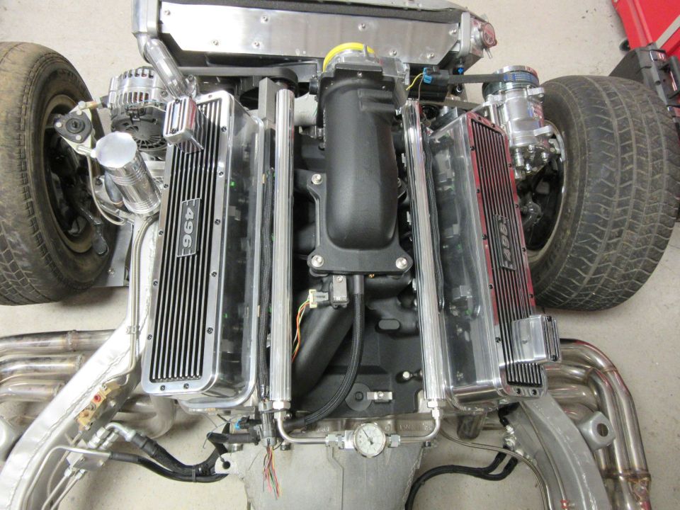 Engine with "496" valve covers and exhaust headers, front tire visible.