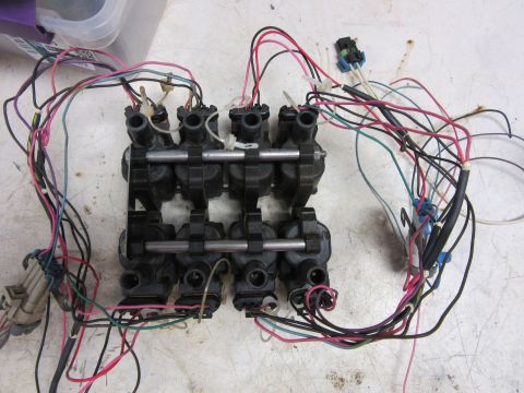 Eight black ignition coils with a multi-colored wiring harness.