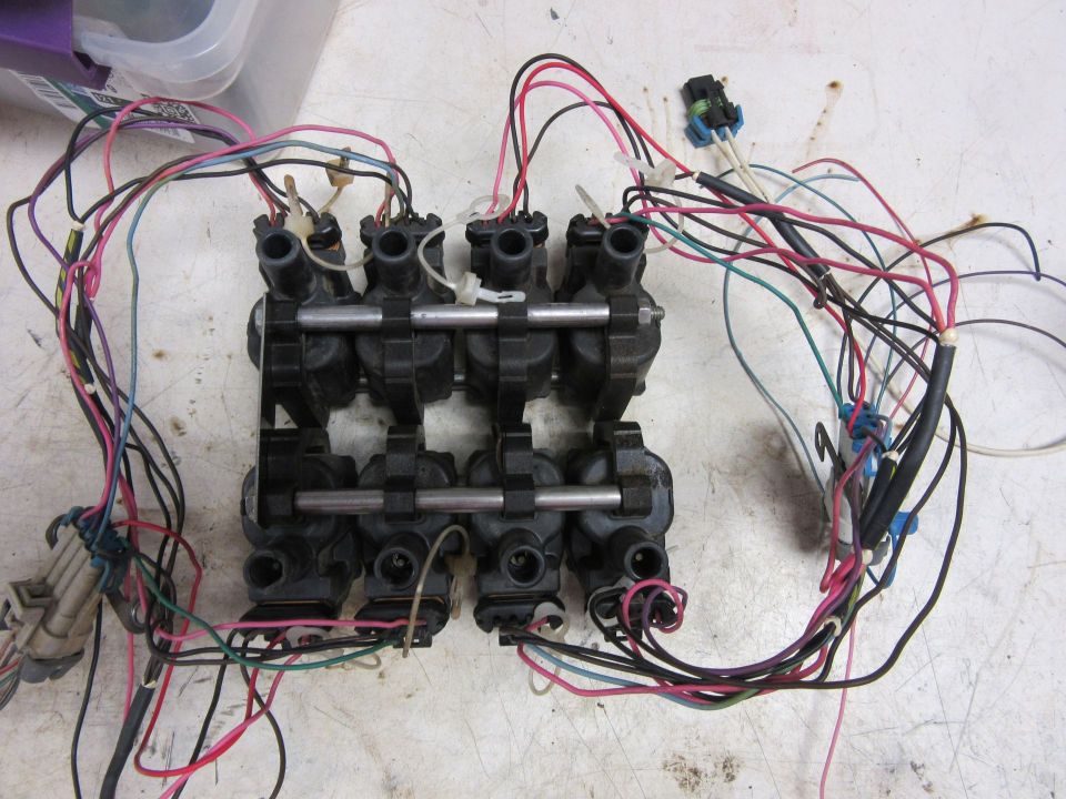 Eight black ignition coils with a multi-colored wiring harness.