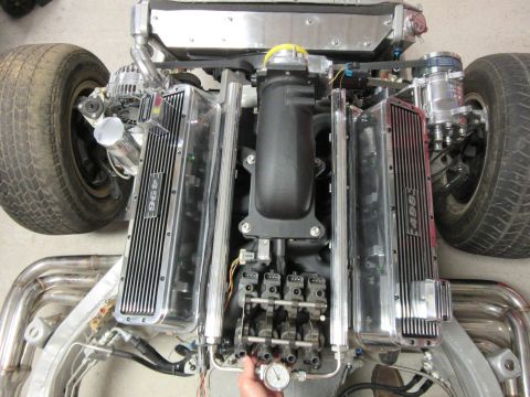Overhead view of a custom 496 engine with chrome valve covers and stainless steel headers.