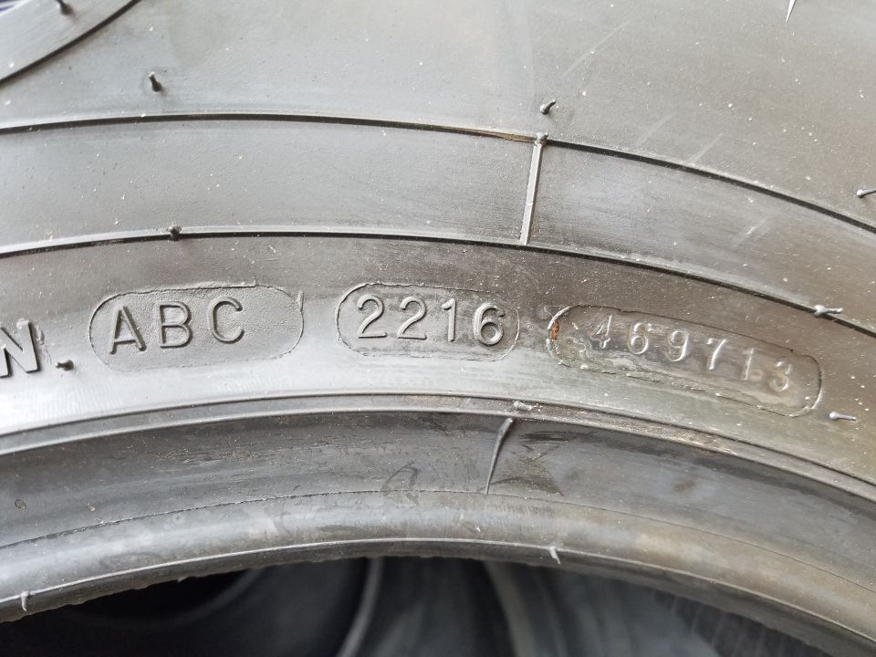 Close-up of a tire with text ABC, 2216, and 469713