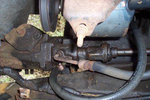 1973 Ford F-250 - This is a close-up view of the power steering system on a 1973 Ford F-250. The steering gear box and hoses are covered in grease and grime.