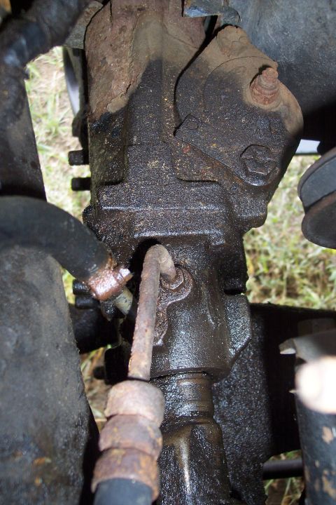 1973 Ford F-250 - This close-up view shows a heavily greased and rusted steering gear box assembly, likely from a 1973 Ford F-250. A hydraulic line is visibl…