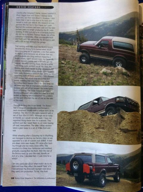 1996 Ford Bronco - A maroon and tan Ford Bronco is parked on a dirt hill with a mountain range in the background. The vehicle is shown from a 3/4 front angle.