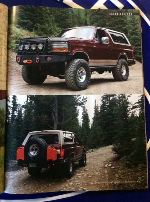 1996 Ford Bronco - A maroon 1996 Ford Bronco is shown from the front 3/4 view and rear 3/4 view on a dirt road surrounded by trees. The front features a custo…
