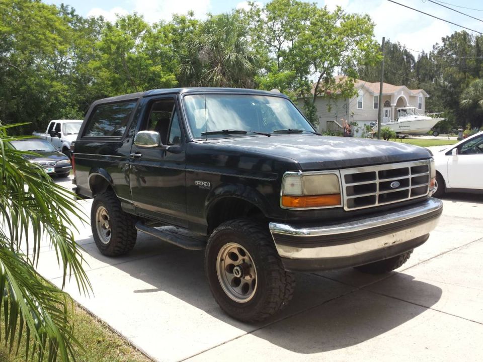 1995 Ford Bronco parked on a driveway.