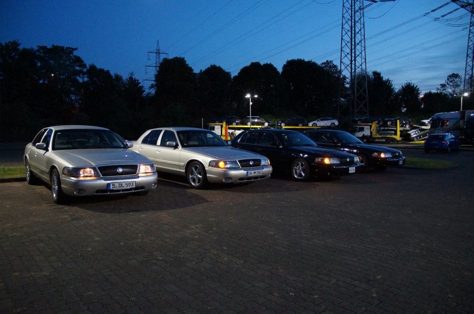 2003 Mercury Marauder and three other sedans parked in a lot at dusk