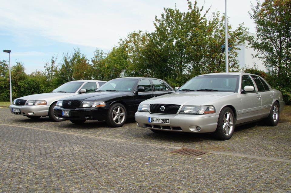 Three Mercury Marauder sedans parked side-by-side. The front car has a license plate reading 'LN MM 2003'