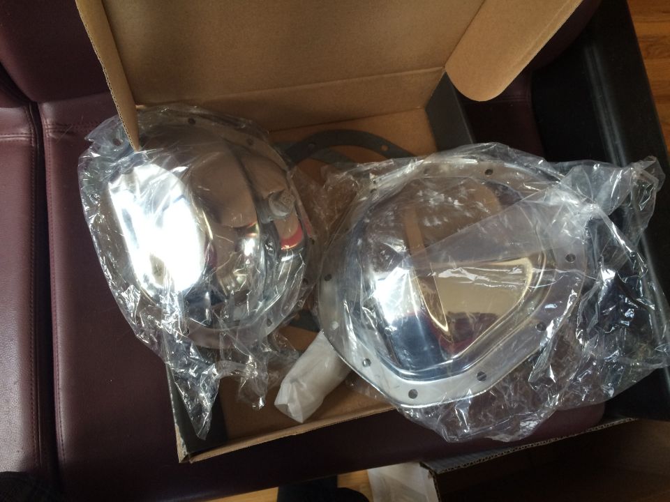 Two chrome differential covers in plastic packaging inside a cardboard box