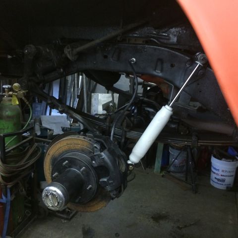 1962 Chevrolet Suburban - The rear suspension and brake components of a vehicle are shown in detail, possibly during maintenance or modification.
