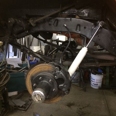 1962 Chevrolet Suburban - A detailed view of a vehicle's rear suspension system, showing components like leaf springs and a shock absorber.