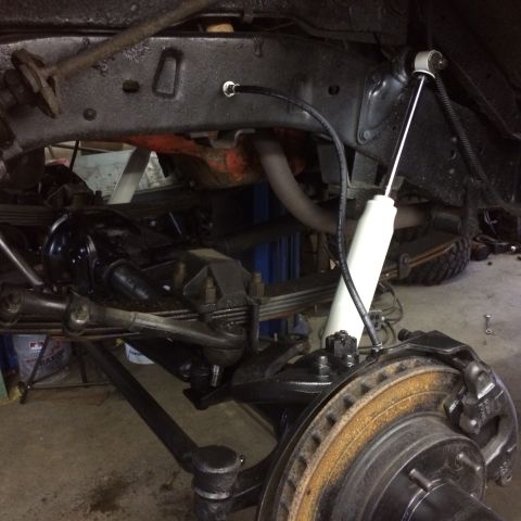 1962 Chevrolet Suburban - Undercarriage view of a vehicle's suspension system, highlighting brake components and shock absorber.