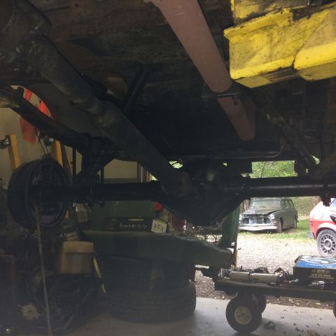 1962 Chevrolet Suburban - The underside of a vintage station wagon is shown, with another vehicle visible in the background.