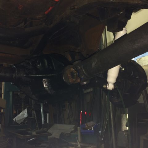 1962 Chevrolet Suburban - Underside view of a vehicle's rear axle and driveshaft assembly, showing suspension components.