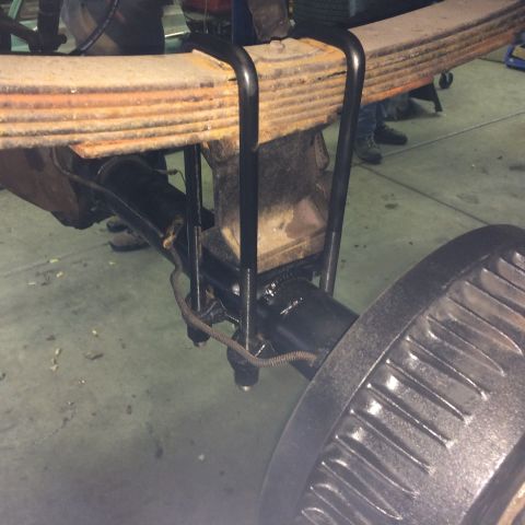 1962 Chevrolet Suburban - Close-up of a vehicle's rear axle and leaf spring assembly, showing suspension components.