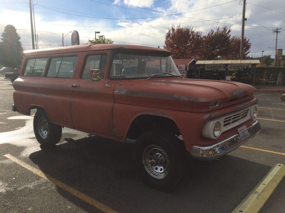 1962 Chevrolet Suburban, red paint, some rust spots, aftermarket wheels