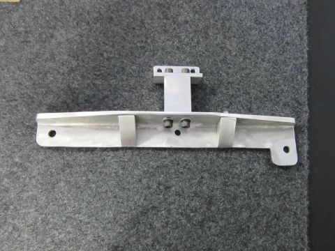 Aluminum bracket with two mounting holes on the left and one on the right, plus a vertical section with four b
