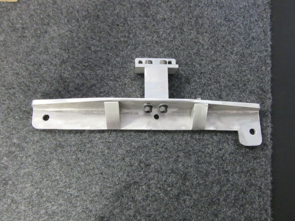 Aluminum bracket with two mounting holes on the left and one on the right, plus a vertical section with four bolt holes