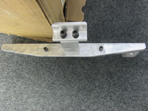 Aluminum bracket with two bolts attached to a larger aluminum piece