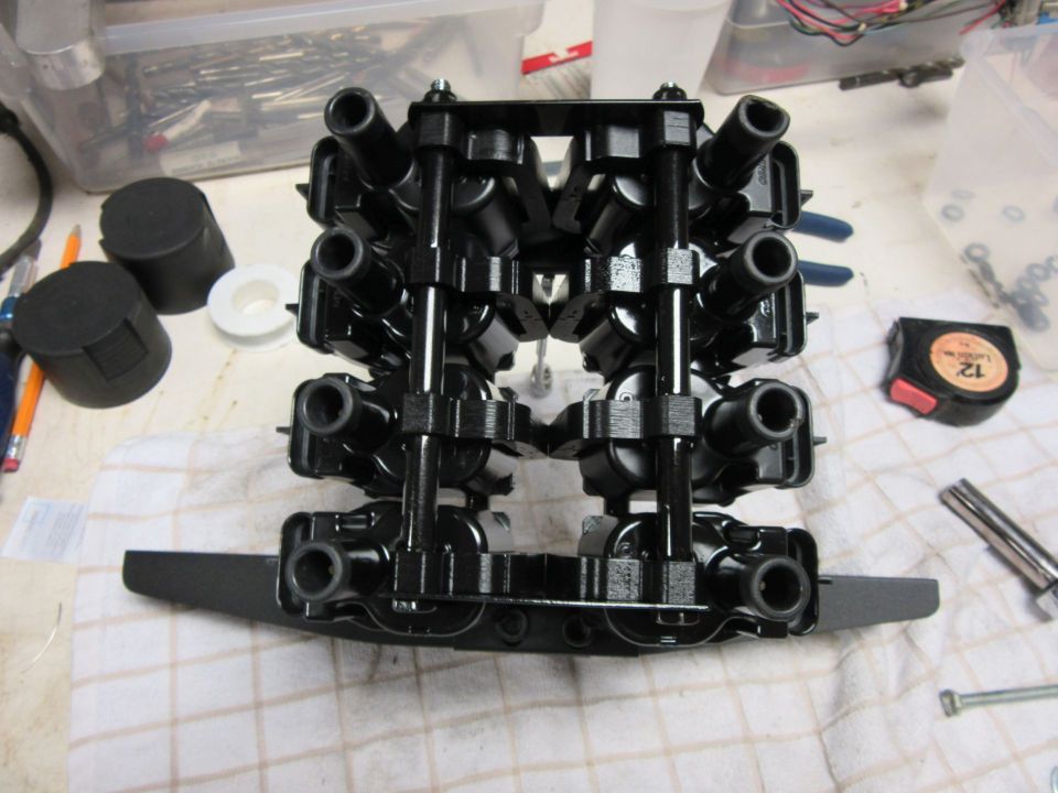 engine ignition coil pack on a table with tools