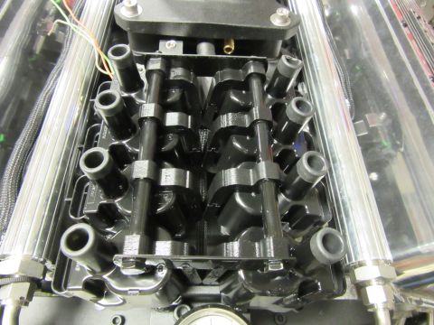 Engine close-up with spark plug wires and intake manifold