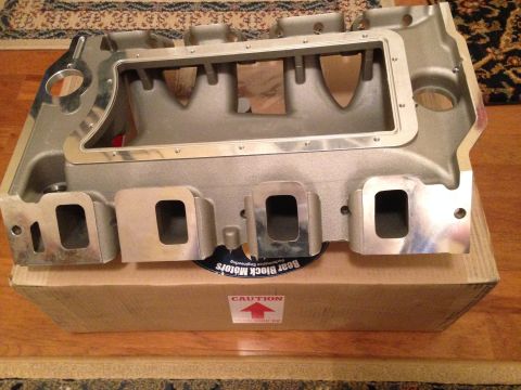 1967 Ford Galaxie - An aluminum intake manifold is shown resting on a cardboard box with caution labels.