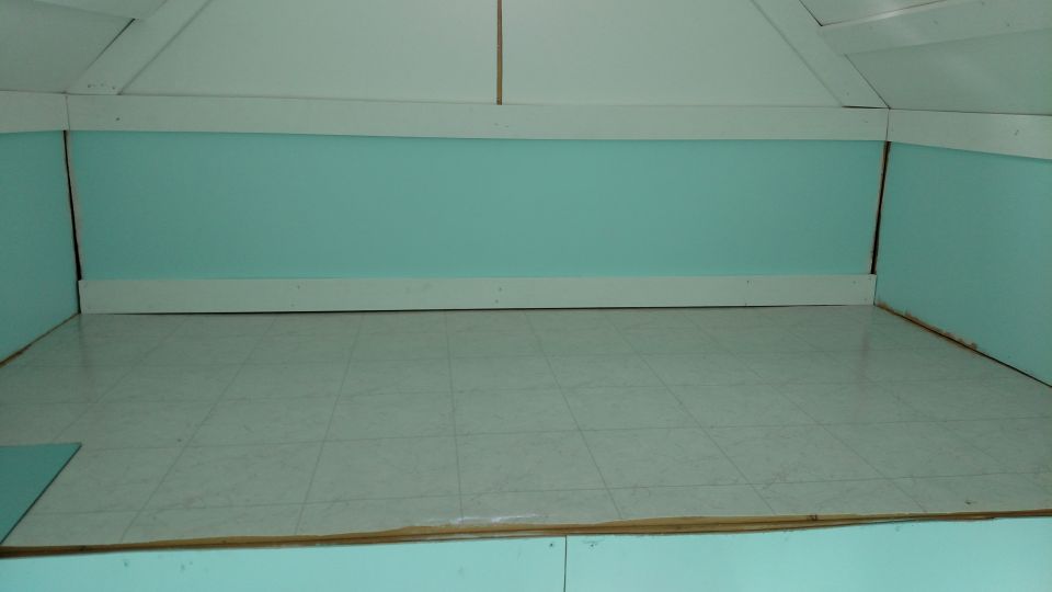 Empty room with tiled floor and light blue walls