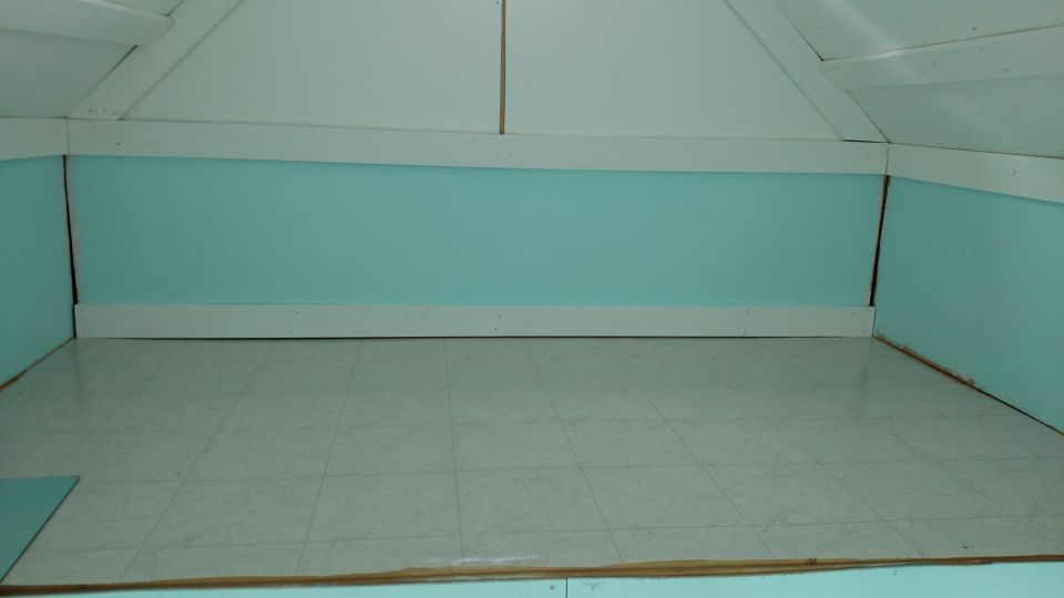 Empty room with light blue walls, white trim, and tiled floor