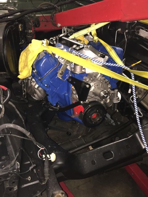 1978 Ford Bronco - Engine removal in progress, with a yellow towel draped over the engine block.