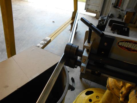 1992 Ford Bronco - A metal roller machine with the Woodward logo is shown in a workshop setting.