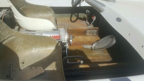 1970 Ford Five Hundred - Interior view of a boat, highlighting the engine, steering wheel, and foot pedals.