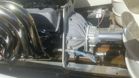 1970 Ford Five Hundred - Close-up view of engine and transmission components, including exhaust headers and a battery.