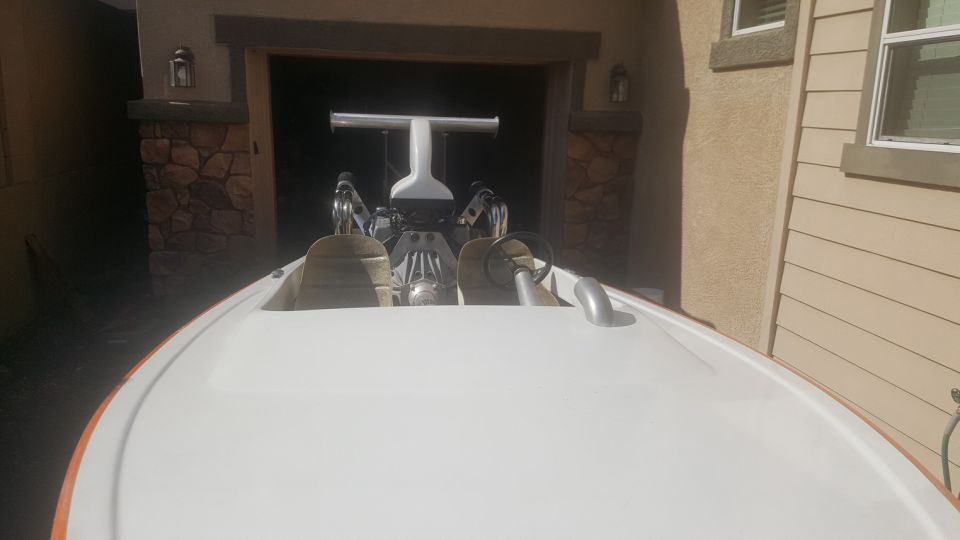 Boat's engine and two seats visible from the front. White T-bar structure behind seats