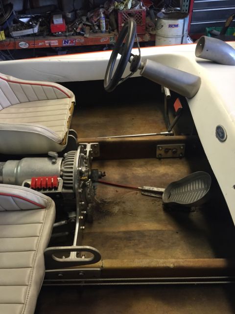 1970 Ford Five Hundred - Interior view of a boat's cockpit, a steering wheel, throttle, and engine components.