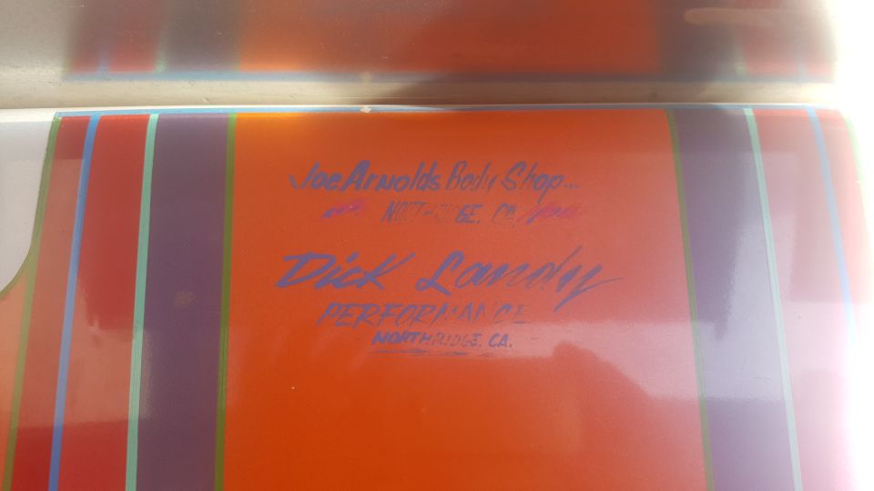 Orange panel with purple, red, and green stripes. Text reads 'Joe Arnold's Body Shop' and 'Dick Landy PERFORMANCE'