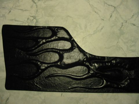 1981 Ford Bronco - This black door panel features an embossed flame design, likely a custom interior modification.