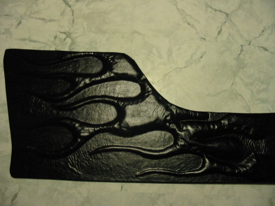 Black door panel with embossed flame design
