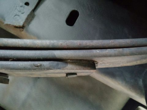 1992 Ford Bronco - Close-up view of the leaf springs on a vehicle's undercarriage.