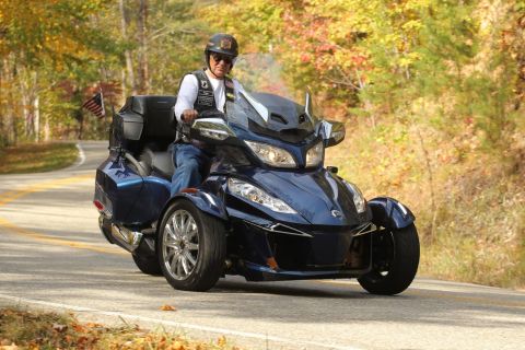 2014 Harley-Davidson FXDWGI Wide Glide - Rider on a blue Can-Am Spyder F3-S motorcycle travels on a scenic road during autumn.